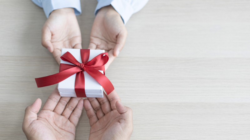Two hands with present