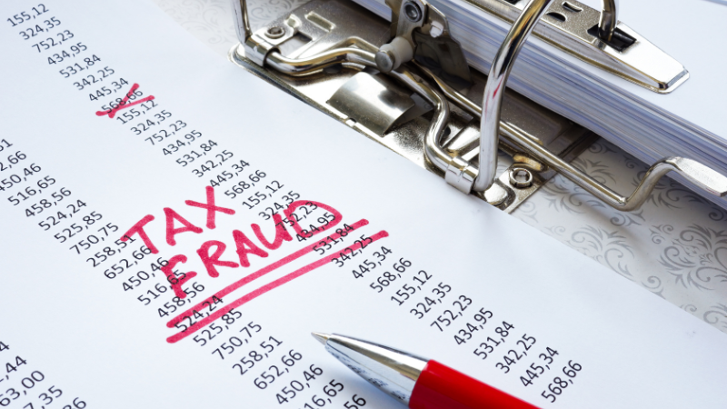 Tax fraud written on paper with numbers