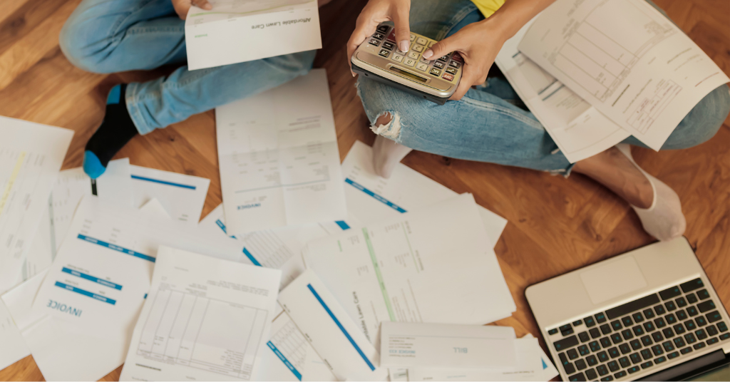 person with paperwork around them on floor