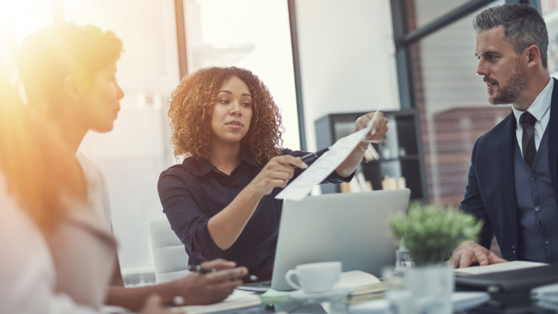 Professionals looking over a document in office