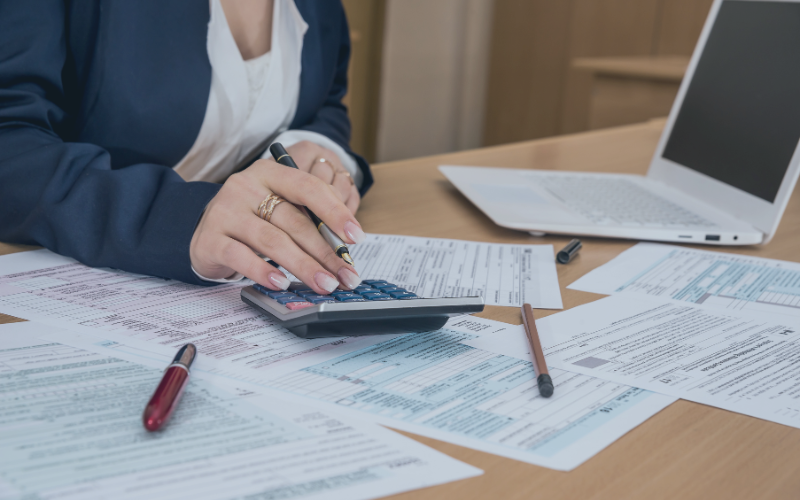 Woman with calculator and documents
