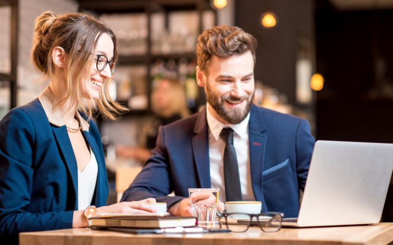 Two people working together looking at computer